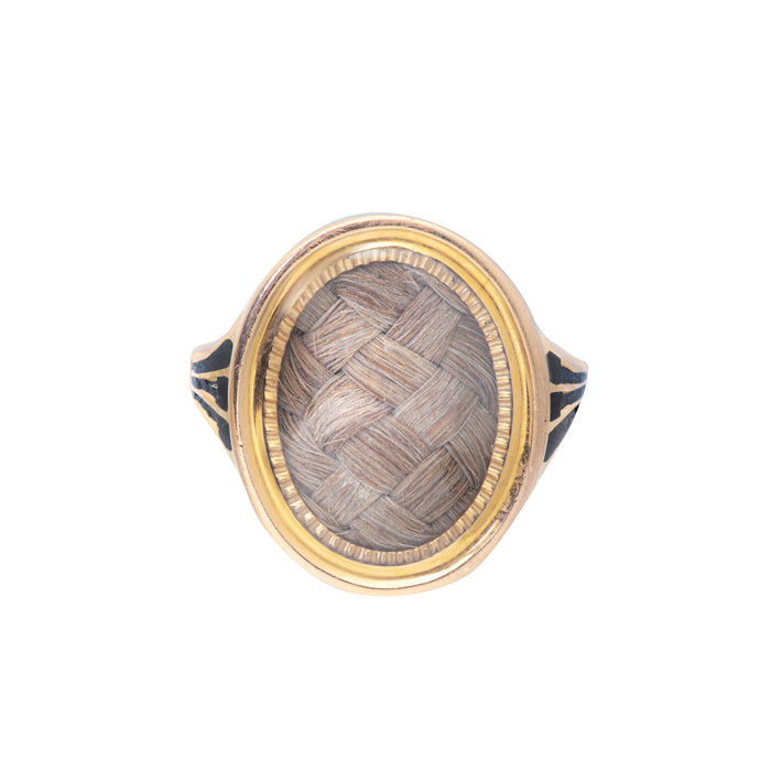 Georgian mourning ring in 15ct gold with plaited hair under domed glass and black enamel border, c.18th century.