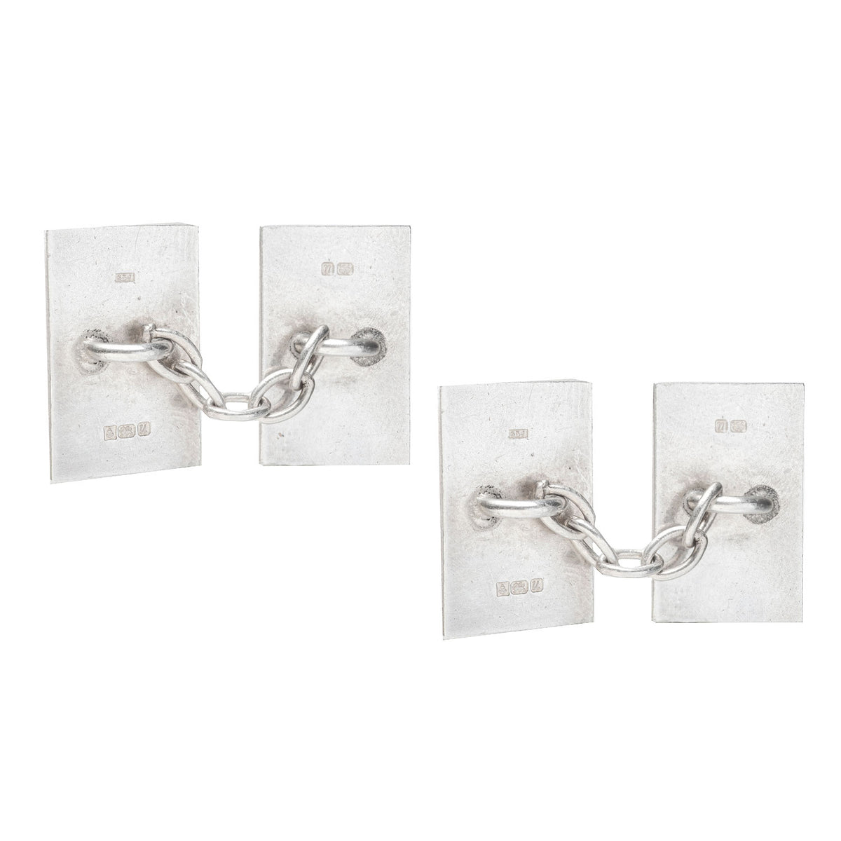 Rectangular 1990s silver cufflinks featuring repeating honeycomb enamel design on black ground.