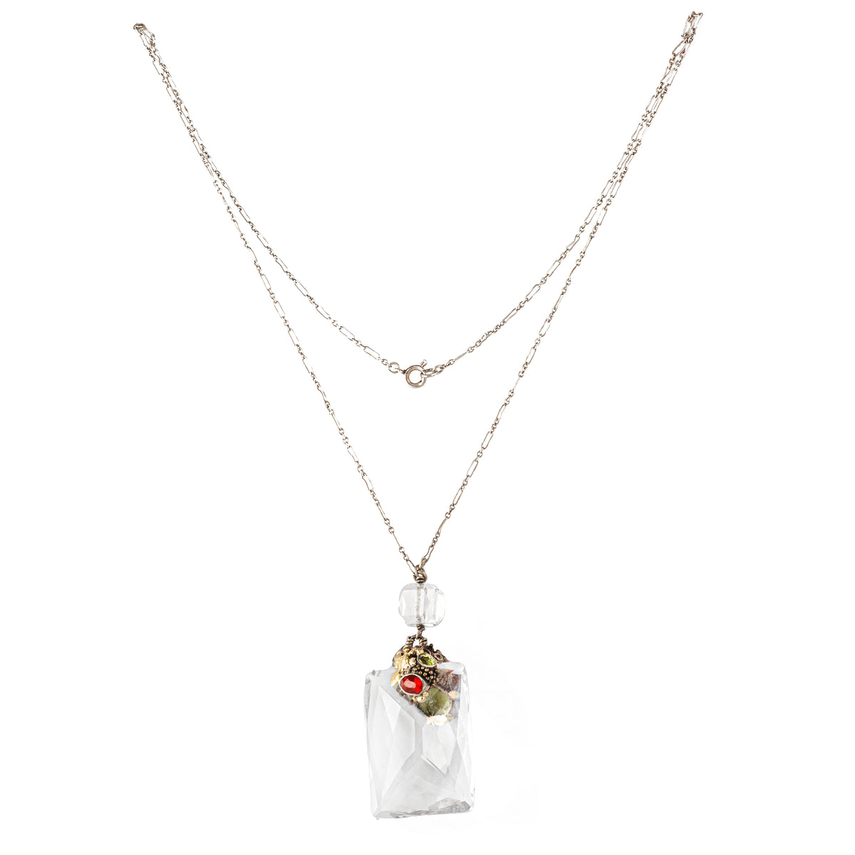 Full view of a Dorrie Nossiter pendant necklace, showcasing a faceted rock crystal drop with clustered gemstones in an ornate setting.