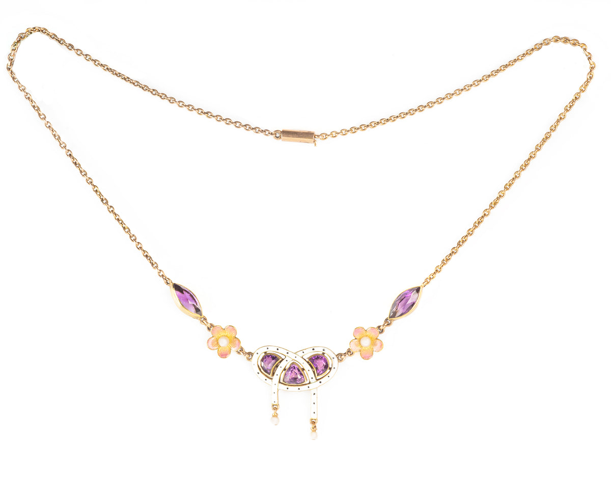 Delicate antique gold necklace featuring white and pink enamel, amethysts, and floral detail, likely English or Austrian.