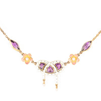 Gold and enamel Edwardian necklace with lover’s knot, pear-shaped amethysts, and enamel flowers, c.1905.