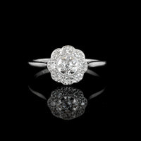 1940s platinum diamond daisy cluster ring with milgrain detail