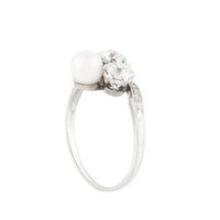 British Art Deco era pearl and diamond ring featuring a twist design and platinum shoulders