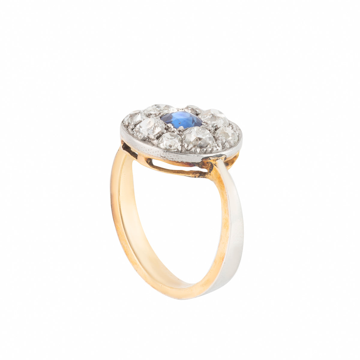 Close up of antique sapphire ring with diamond halo in circular cluster setting