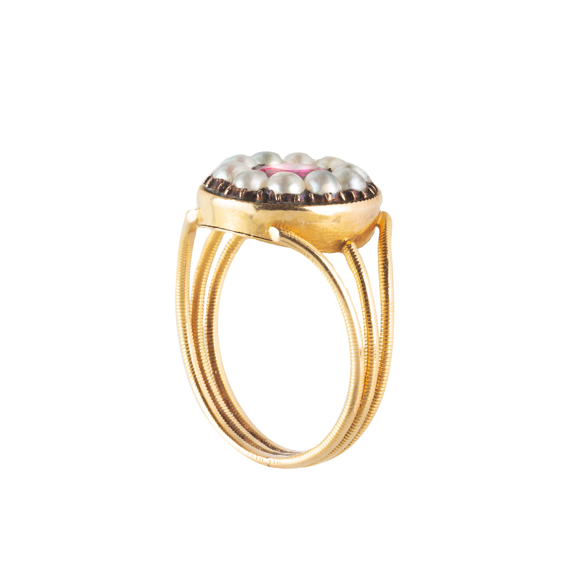 Side view of a Victorian ruby and pearl ring with raised gallery and etched gold band.