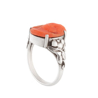 Antique handmade silver ring featuring an orange coral carved face and foliate shoulders, UK size O.