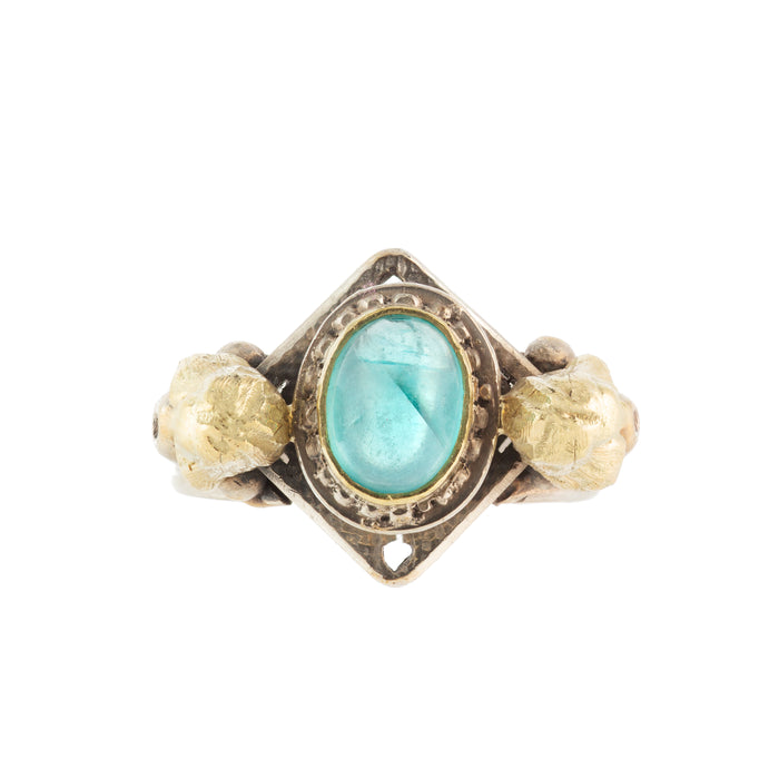 Vintage 1970s Egyptian Revival ring in silver and gold with vivid blue apatite and sculptural lion heads.