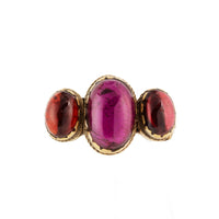 Vintage 9ct gold ring set with three deep red cabochon garnets, central stone larger than side stones.