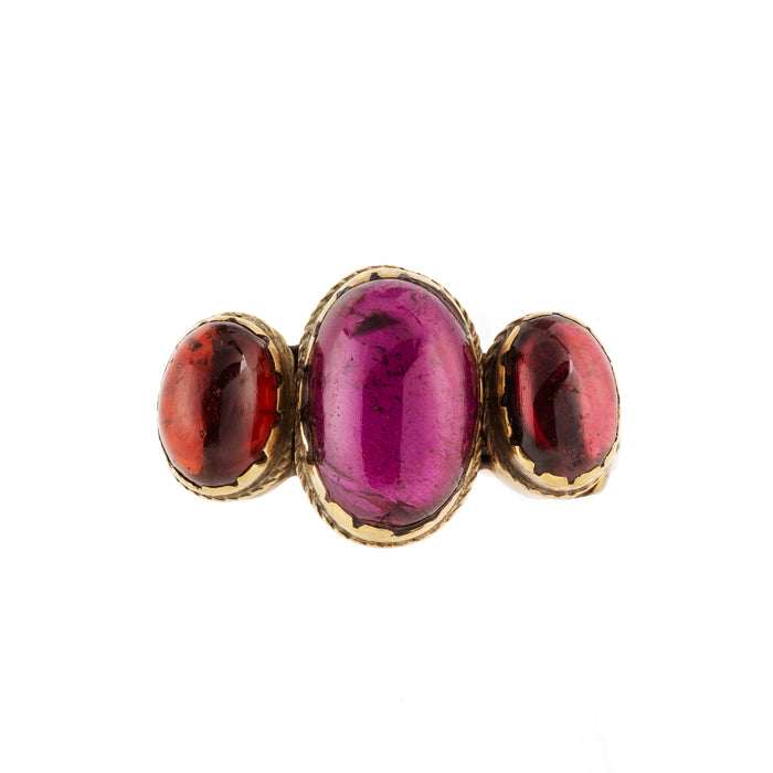 Vintage 9ct gold ring set with three deep red cabochon garnets, central stone larger than side stones.