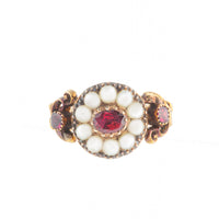 Georgian 15ct gold ring with central garnet and natural pearl cluster, scrolled shoulders and garnet side stones, c.1780.