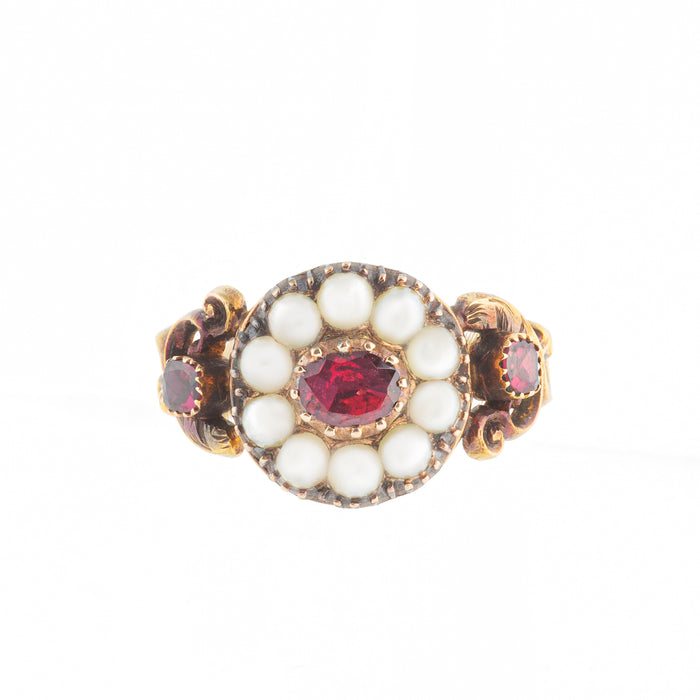 Georgian 15ct gold ring with central garnet and natural pearl cluster, scrolled shoulders and garnet side stones, c.1780.