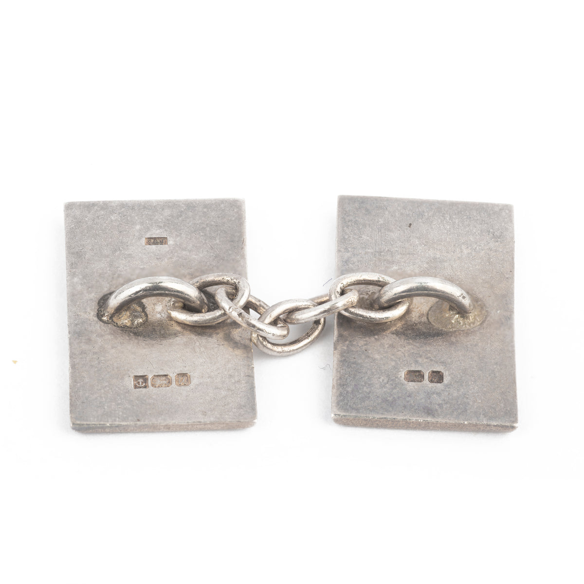 Pair of British silver cufflinks with black enamel scallop pattern, hallmarked Birmingham 1995.