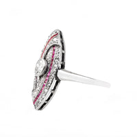 Angled side view of an Art Deco platinum ring with rubies and diamonds, highlighting low profile setting and detailed craftsmanship.