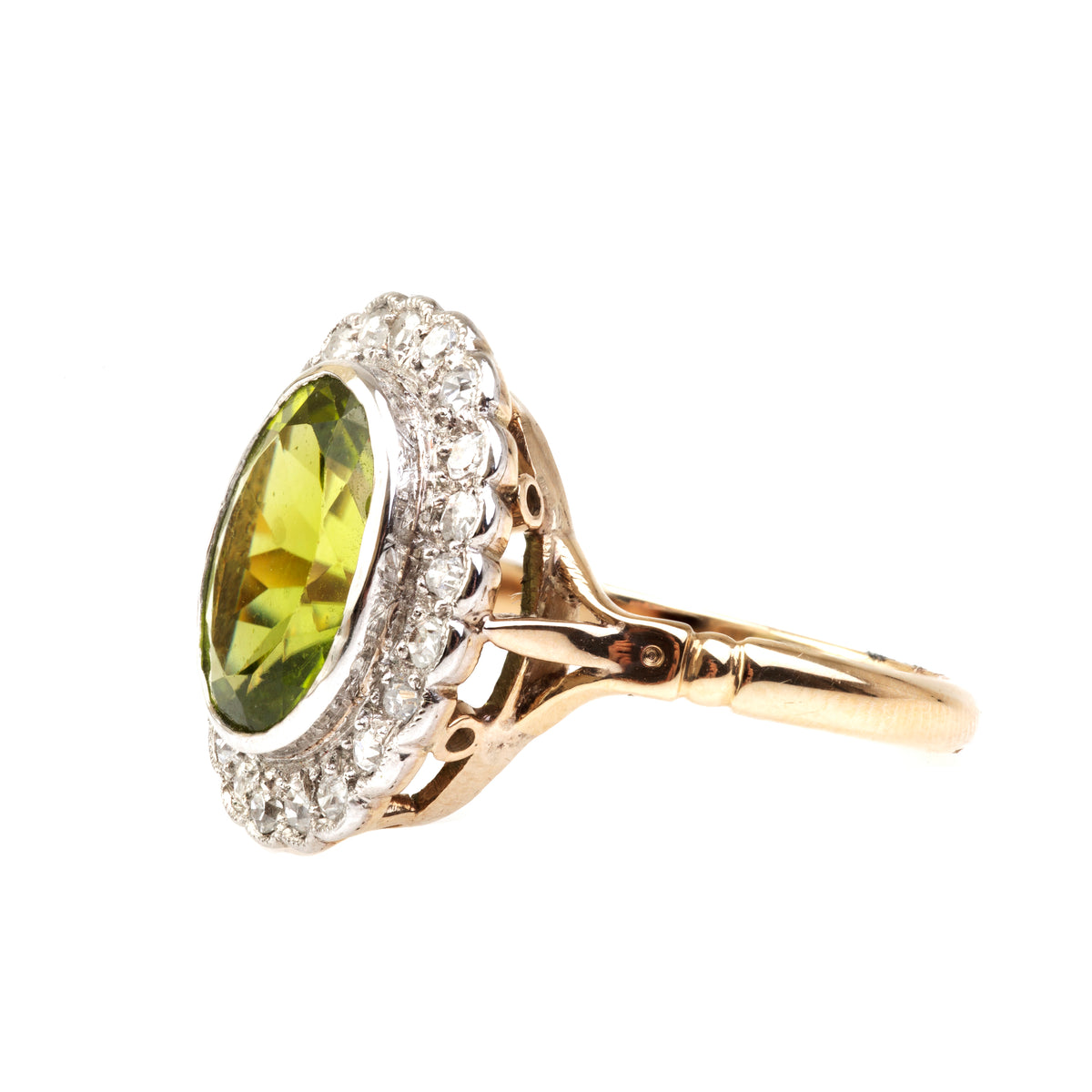 Antique cluster ring with 3.5ct peridot and 0.70ct diamond halo, c.1910.
