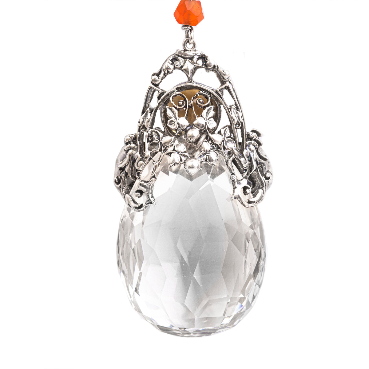 Back of faceted rock crystal pendant by Amy Sandheim with ornate silverwork and gemstone detailing.