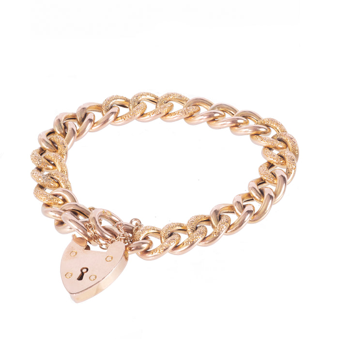Edwardian 9ct gold curb bracelet with engraved and polished links, heart padlock clasp, c.1910s