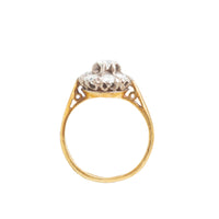 Side profile of vintage 18ct gold diamond ring showing raised cluster setting and openwork gallery.