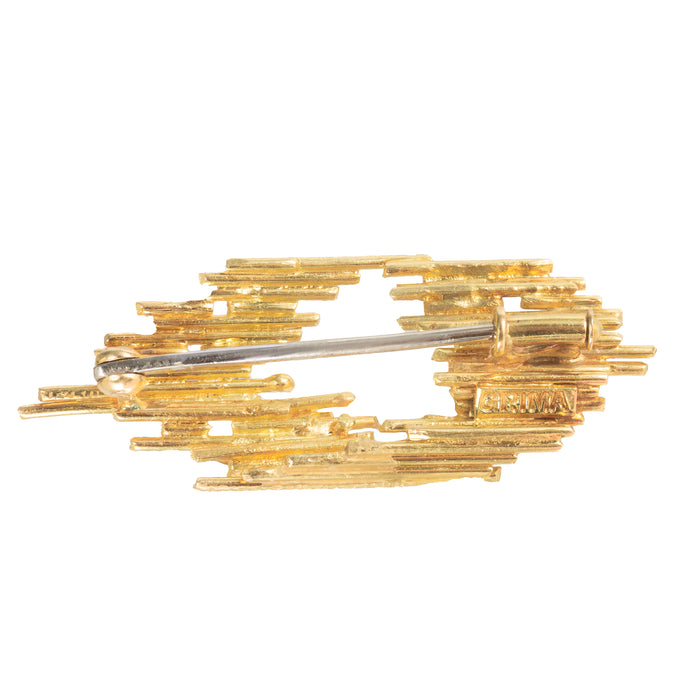 Architectural gold brooch by Andrew Grima with diamond accents and staggered openwork design