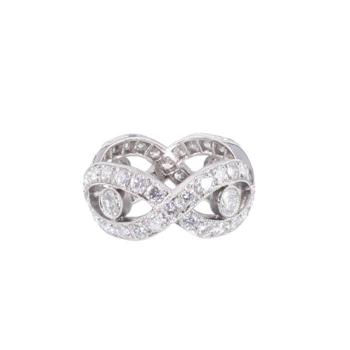 Front view of 1940s French diamond eternity ring with platinum crossover design and 3.15 carats of round brilliant diamonds.
