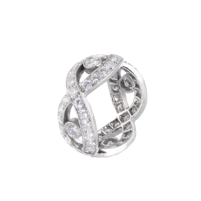 Angled side view of sculptural platinum and gold French eternity ring showcasing diamond detail and structural design.