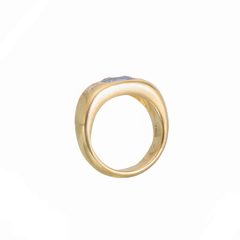 Side view of 1980s 18ct gold gypsy ring showing hallmarks and thick polished band with sapphire