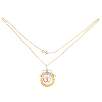 Edwardian ruby and diamond heart pendant with bow, shown on a gold chain (chain not included)
