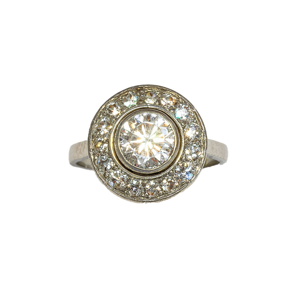 Front view of French Art Deco diamond target ring in platinum, featuring one carat centre diamond and halo of old cut diamonds, circa 1920s.