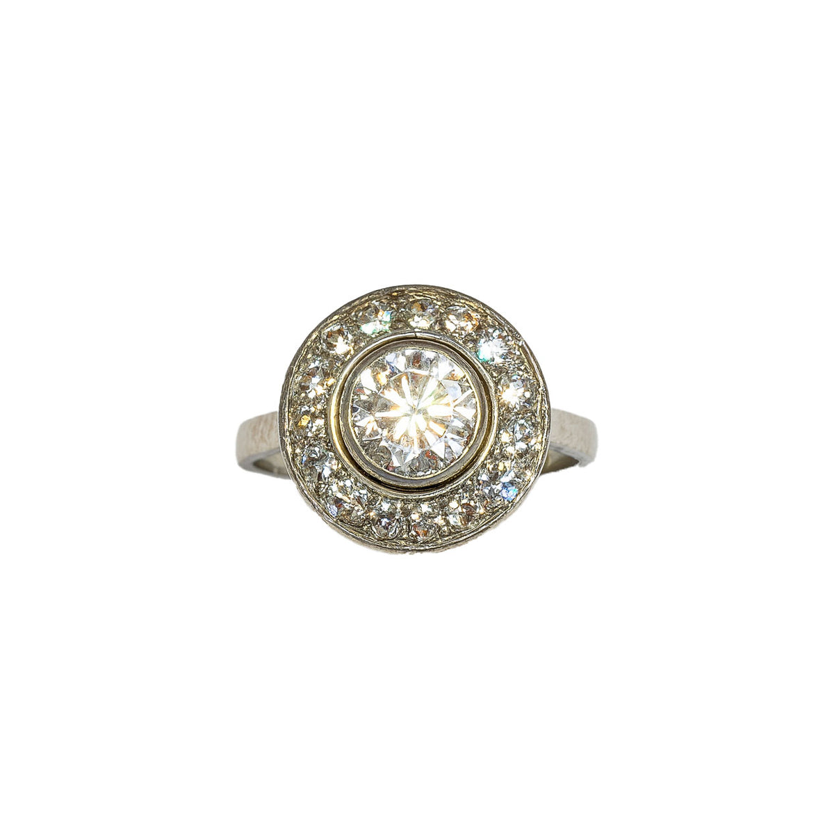 Front view of French Art Deco diamond target ring in platinum, featuring one carat centre diamond and halo of old cut diamonds, circa 1920s.