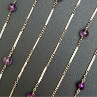 Close-up view of twisted sterling silver bar links and polished amethyst beads in a 148cm antique necklace