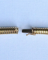 Close-up of integrated clasp on 18ct gold Tubogas necklace, showing mechanism