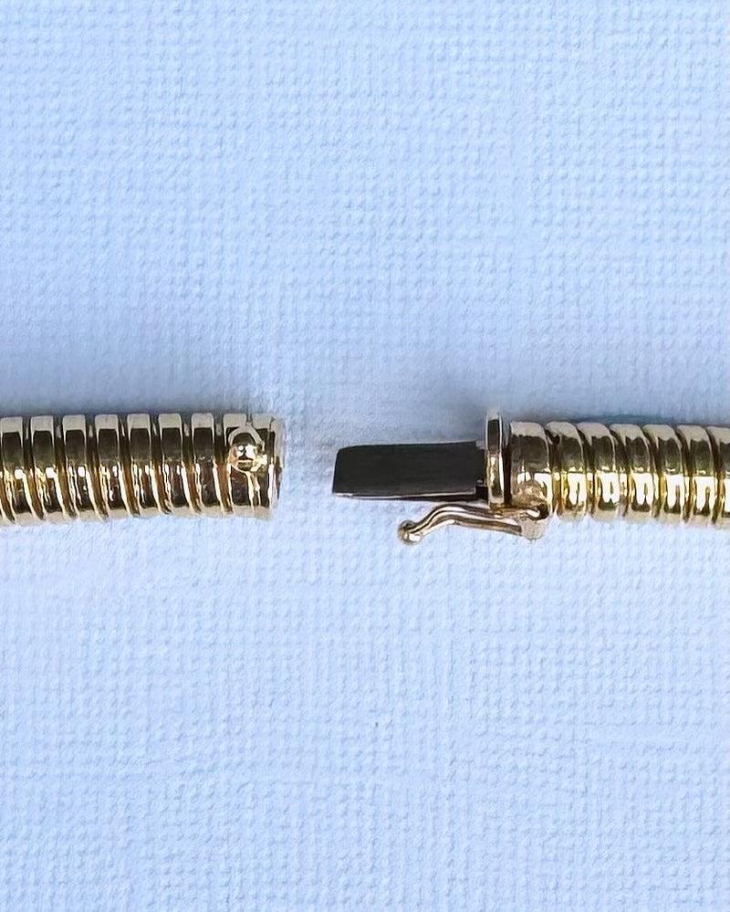 Close-up of integrated clasp on 18ct gold Tubogas necklace, showing mechanism