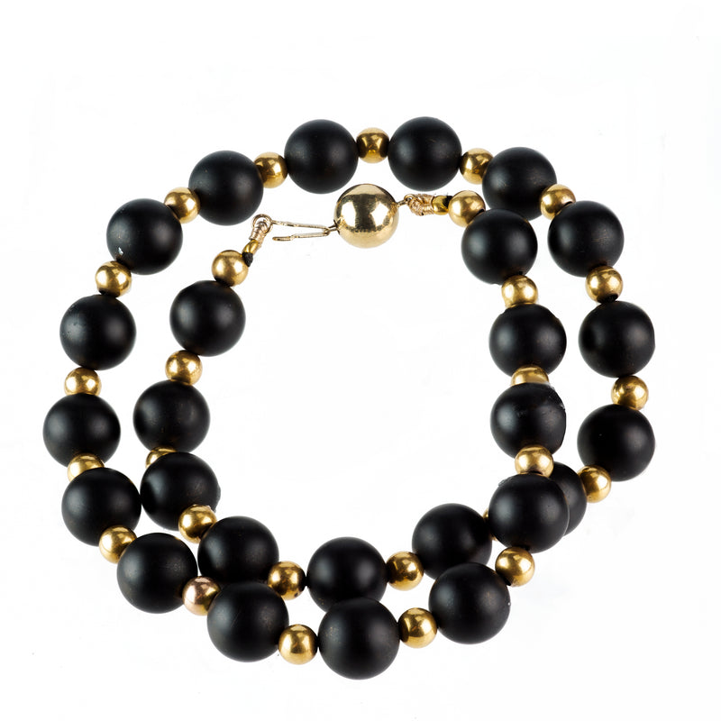 Close-up of 1960s Italian onyx and 14ct gold bead necklace showing contrast and clasp detail