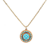 Close-up of antique turquoise and diamond dome locket with Etruscan Revival detail