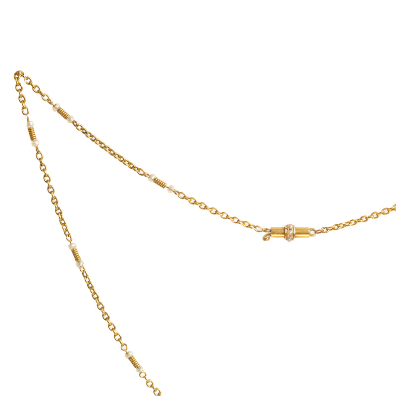 Close up of the antique 15ct gold and pearl chain, showing the delicate seed pearls and intricate coiled gold workmanship along the links.
