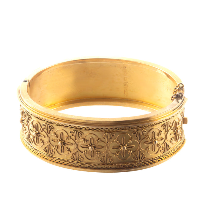 Detailed view of Victorian 15ct gold bangle with applied granulation, ropework, and engraved rosette motifs, hallmarked Chester 1867.