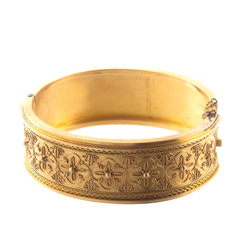 Detailed view of Victorian 15ct gold bangle with applied granulation, ropework, and engraved rosette motifs, hallmarked Chester 1867.
