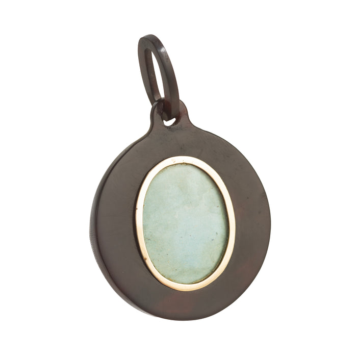 Reverse view of the Victorian piqué pendant showing the glazed locket compartment framed in gold for a keepsake or photograph, c.1880s.