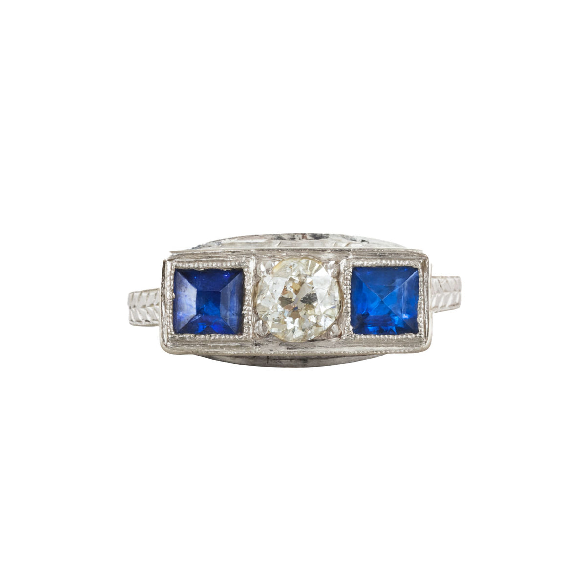 Art Deco sapphire and diamond ring in platinum and 14ct gold, featuring an old European cut diamond between two French cut sapphires, c.1930s.
