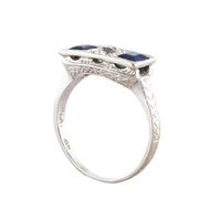 Side profile of 1930s Art Deco sapphire and diamond ring showing engraved shoulders, millegrain setting and pierced gallery detail.