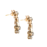 Side view of Edwardian Lily of the Valley diamond earrings, c.1910s, highlighting the tapered floral drops and silver topped 15ct gold settings with old cut diamonds.
