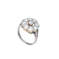 Side profile of Edwardian 18ct gold and platinum daisy diamond ring showing raised open collet design and millegrain detail.