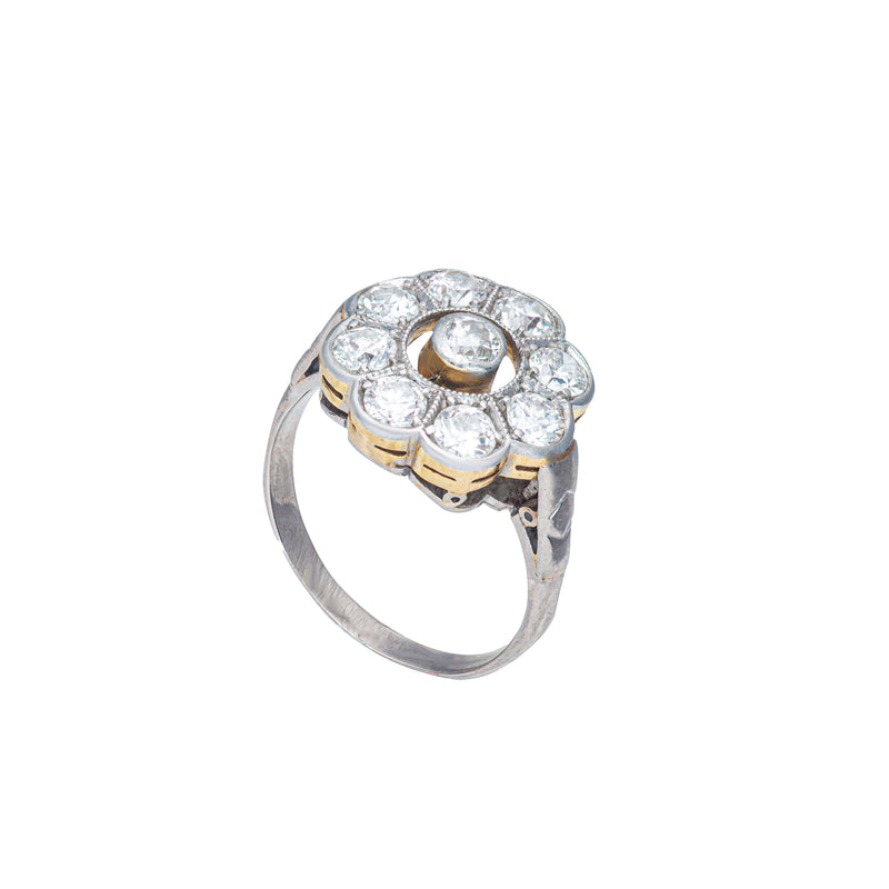 Side profile of Edwardian 18ct gold and platinum daisy diamond ring showing raised open collet design and millegrain detail.