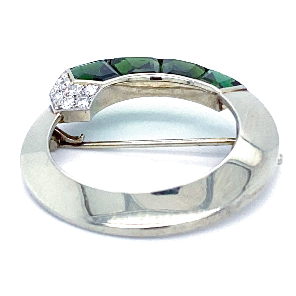 Reverse view of Gübelin 1930s tourmaline and diamond brooch, showing 18ct white gold circular frame and pin fitting.
