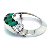 Side angle of Gübelin 1930s circular brooch with step-cut green tourmalines and diamond accents in 18ct white gold.

