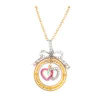 Edwardian 18ct gold pendant with ruby and diamond hearts knotted beneath a diamond bow, c.1910
