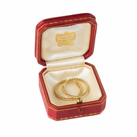 Cartier 1970s gold earrings displayed in original 1930s red box.