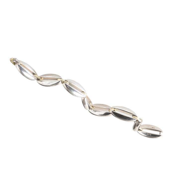Sculptural silver and 18ct gold Regitze Overgaard bracelet laid flat – Georg Jensen, 1980s