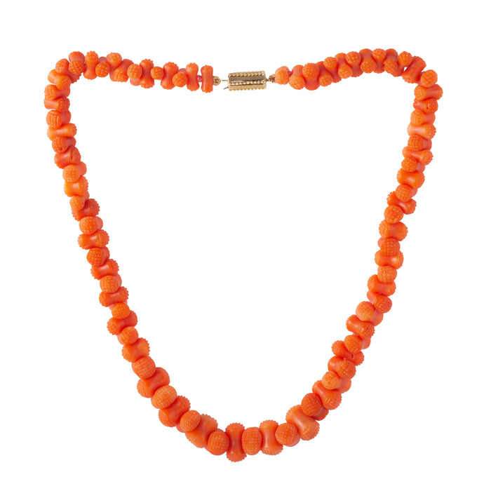 Full view of antique carved coral bead necklace with gold clasp