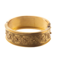 Side view of antique 15ct gold bangle with intricate embossed Etruscan-style design.