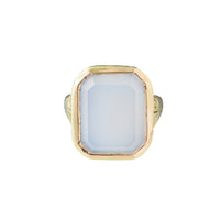 Top view of an octagonal white chalcedony ring set in 14ct gold with engraved shoulders.